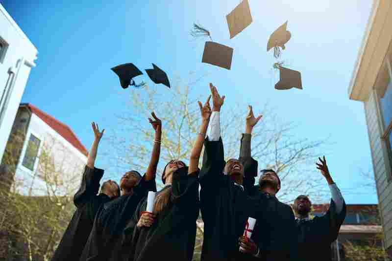 Graduation caps toss