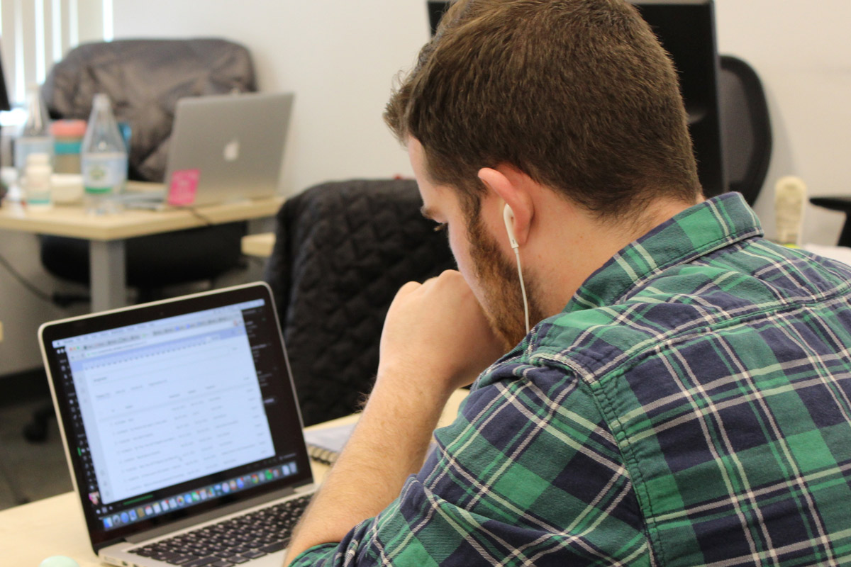 PrepScholar team member at work on a laptop.