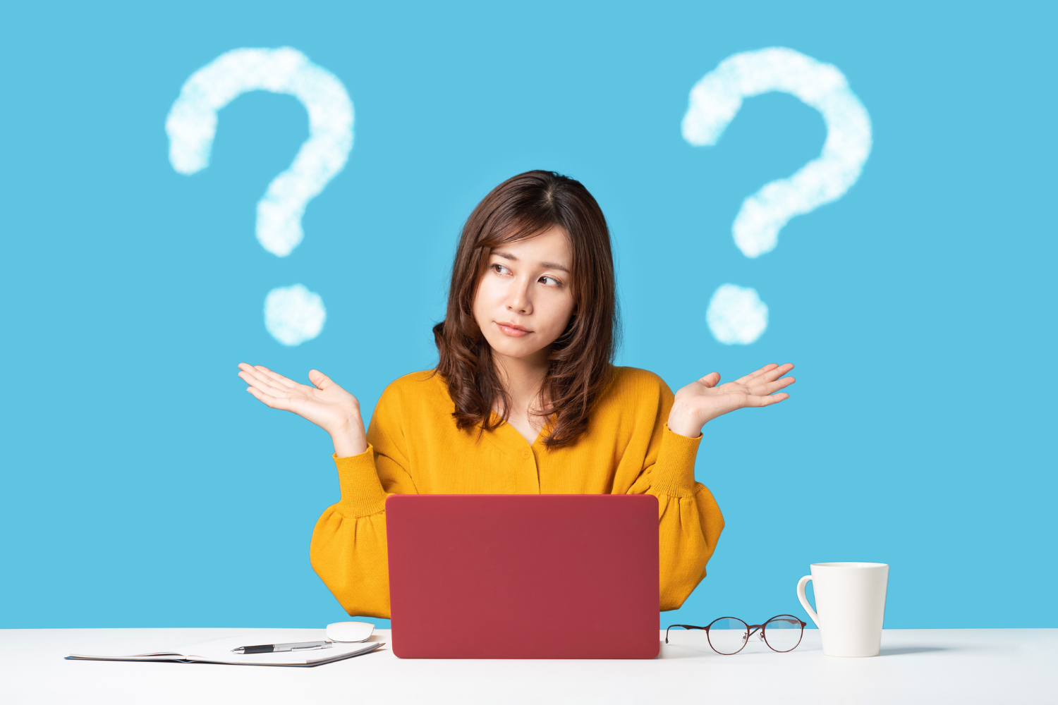 woman at laptop with question marks