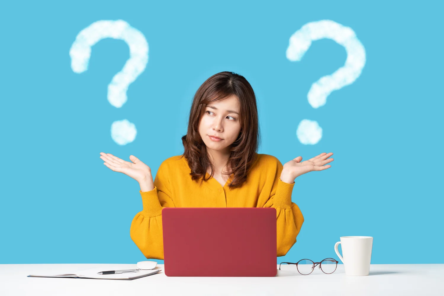 woman at laptop with question marks